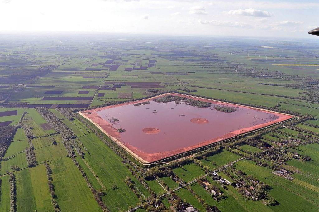 Image of a Red Mud (bauxite residue from the Bayer Process) laggon in Norther Germany. (Source Wikipedia).